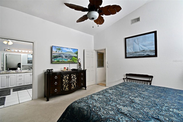 bedroom featuring light carpet, ceiling fan, ensuite bathroom, and lofted ceiling