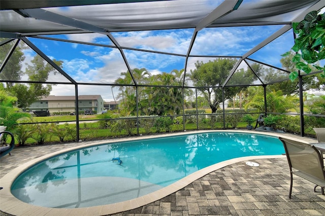 view of swimming pool featuring a lanai and a patio area