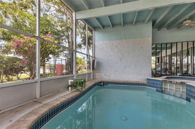 view of swimming pool with a hot tub