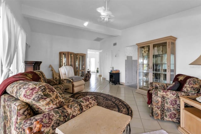 living room featuring beam ceiling, ceiling fan, light tile patterned floors, and a healthy amount of sunlight