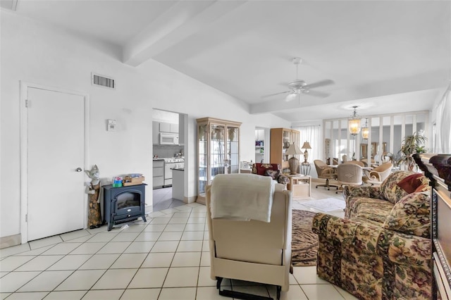 tiled living room with ceiling fan and lofted ceiling with beams