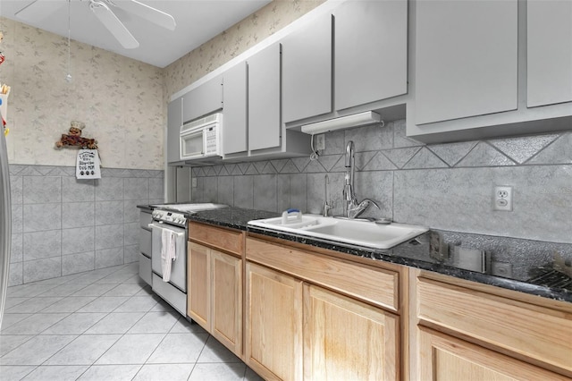 kitchen with range with electric cooktop, ceiling fan, sink, light tile patterned floors, and light brown cabinets