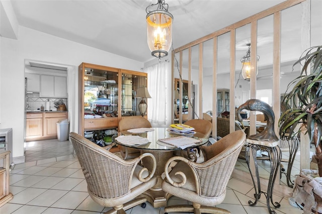 dining space featuring light tile patterned flooring and a chandelier