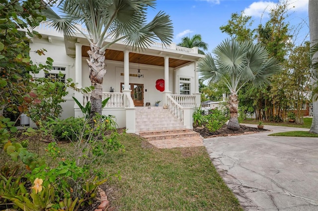 view of exterior entry with covered porch