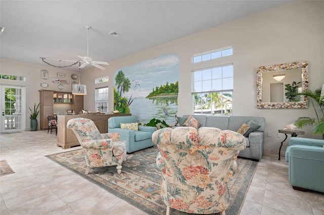 living room with ceiling fan, light tile patterned floors, and a wealth of natural light