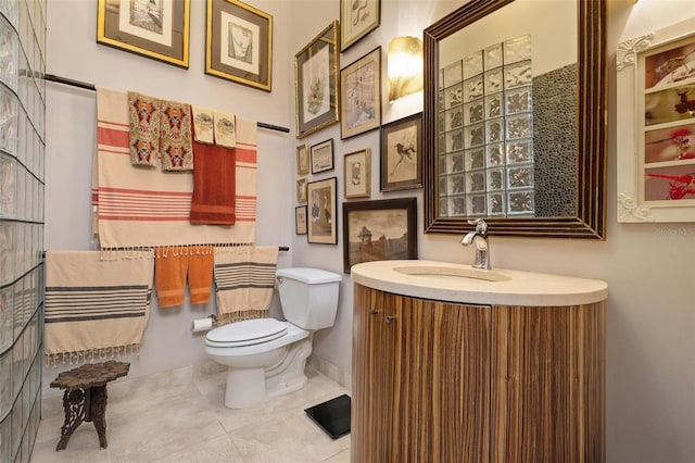 bathroom featuring toilet, tile patterned flooring, and vanity