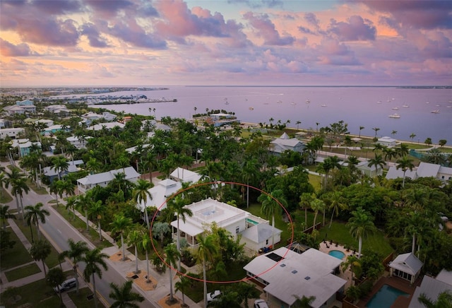 aerial view at dusk with a water view