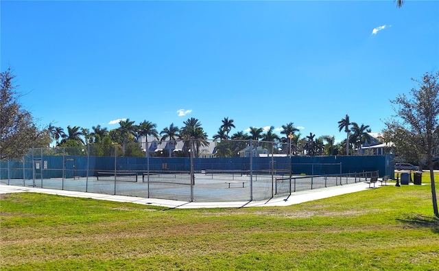 view of sport court featuring a lawn