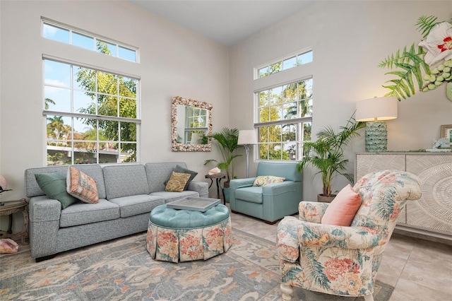 sitting room with a high ceiling and light tile patterned floors