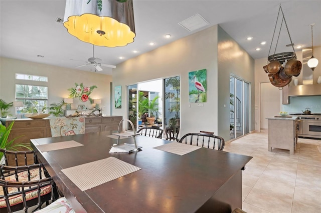 tiled dining space featuring ceiling fan