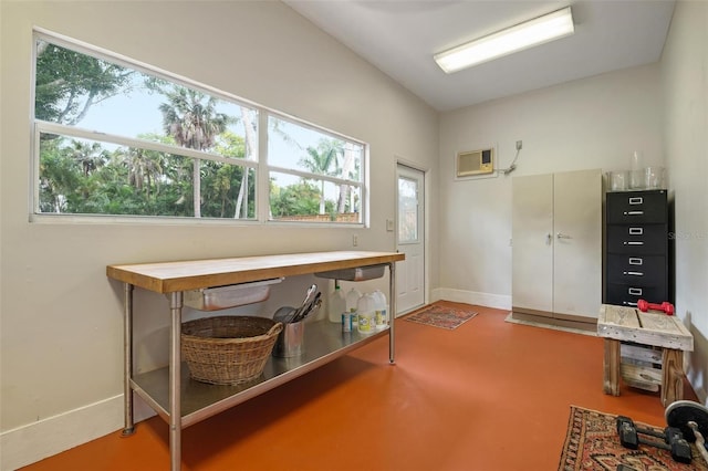 office featuring a wall mounted AC and concrete flooring