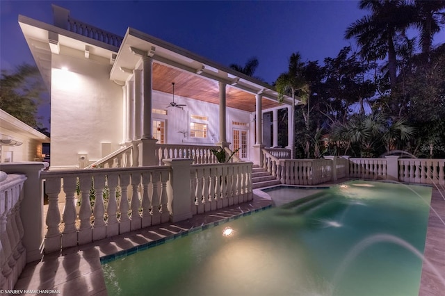 pool at twilight featuring ceiling fan