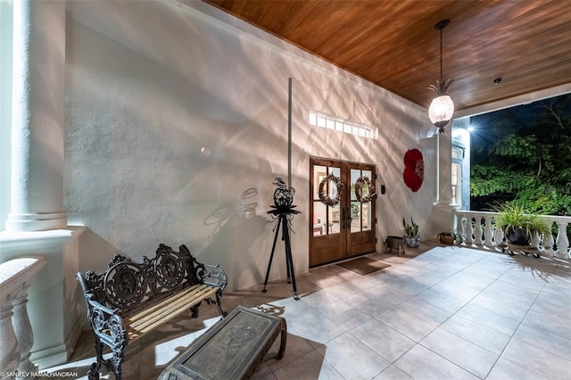 tiled foyer entrance with french doors and wood ceiling