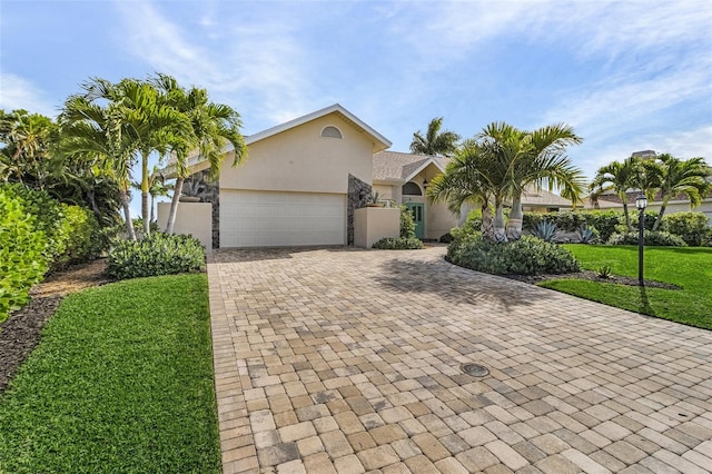 view of front of home featuring a front yard and a garage