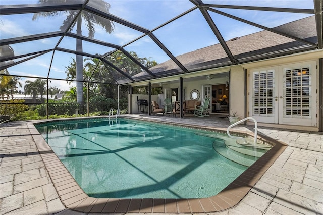 view of pool featuring ceiling fan, a patio area, and a lanai