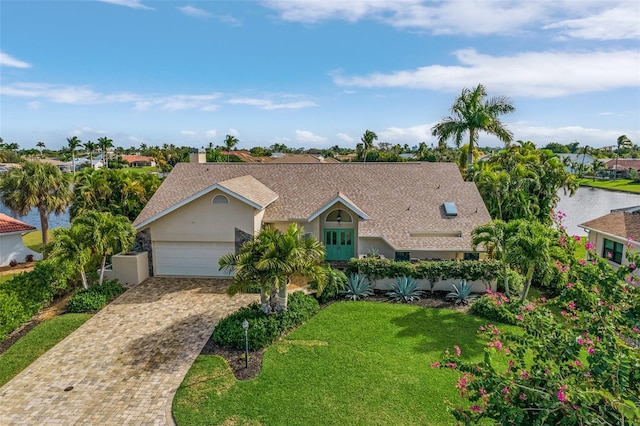 view of front of property featuring a front yard and a garage