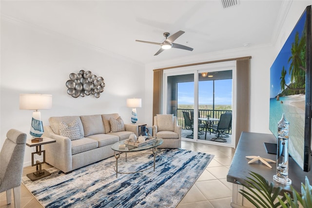 living room with ornamental molding, light tile flooring, and ceiling fan