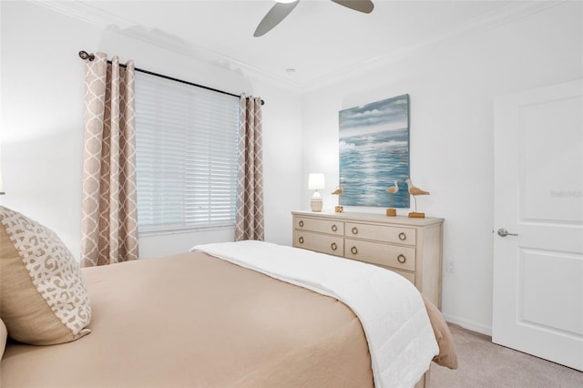 carpeted bedroom with ornamental molding and ceiling fan