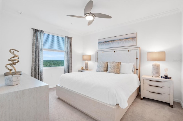 carpeted bedroom with ceiling fan and crown molding