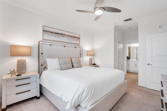 carpeted bedroom featuring ensuite bathroom, ceiling fan, and crown molding