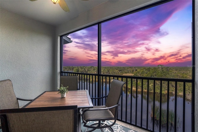 sunroom featuring ceiling fan