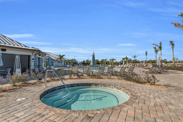 view of pool featuring a patio and a hot tub