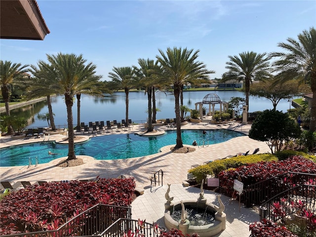 view of pool featuring a patio and a water view