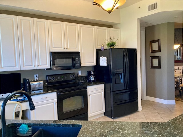 kitchen with white cabinets, black appliances, and light tile patterned floors