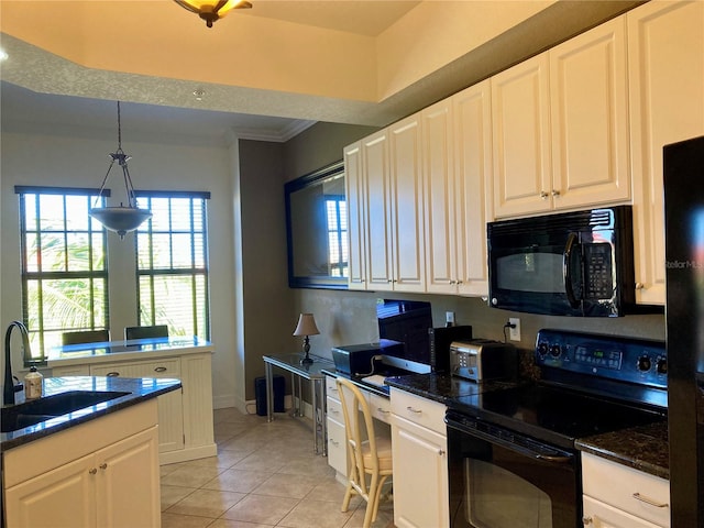 kitchen with hanging light fixtures, sink, white cabinetry, and black appliances