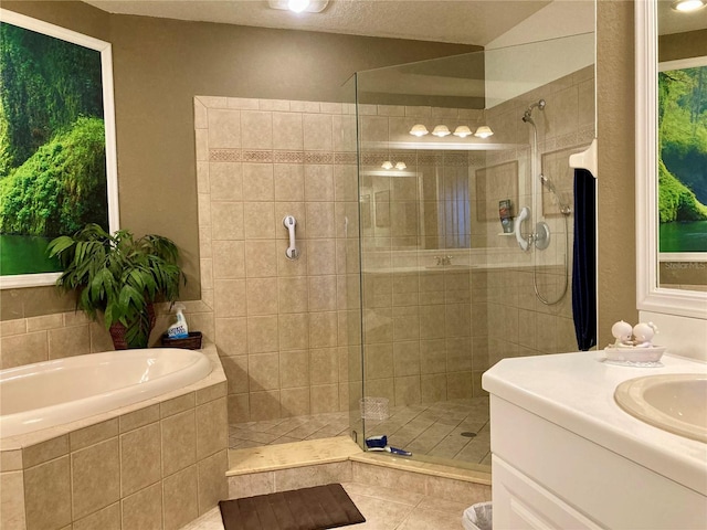 bathroom featuring tile patterned flooring, shower with separate bathtub, and vanity