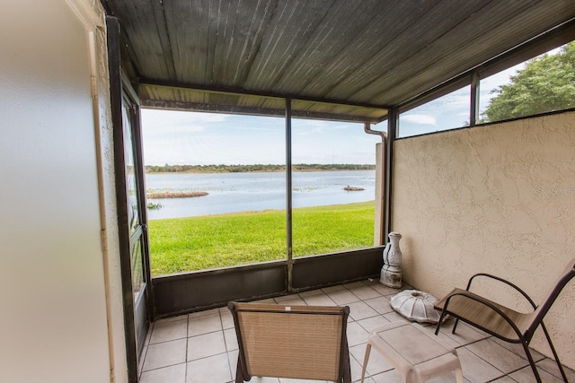 unfurnished sunroom with a water view, a healthy amount of sunlight, and wooden ceiling