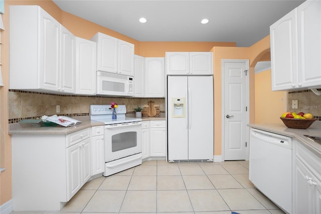 kitchen featuring white cabinetry and white appliances