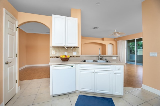 kitchen featuring white cabinetry, sink, light tile patterned flooring, and white dishwasher