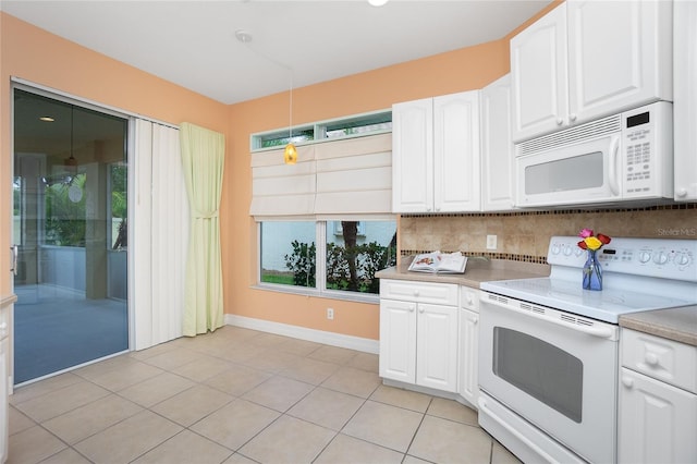 kitchen with decorative light fixtures, tasteful backsplash, white cabinets, light tile patterned floors, and white appliances