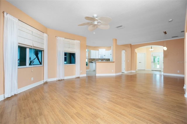 unfurnished living room with ceiling fan and light wood-type flooring