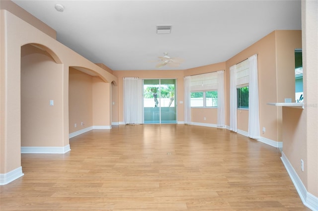 spare room with ceiling fan and light wood-type flooring