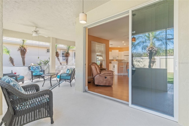 sunroom featuring ceiling fan