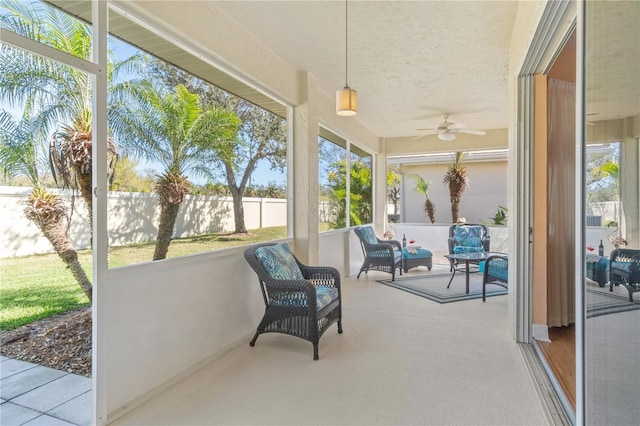 sunroom featuring ceiling fan