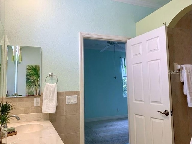 bathroom with vanity and tile walls