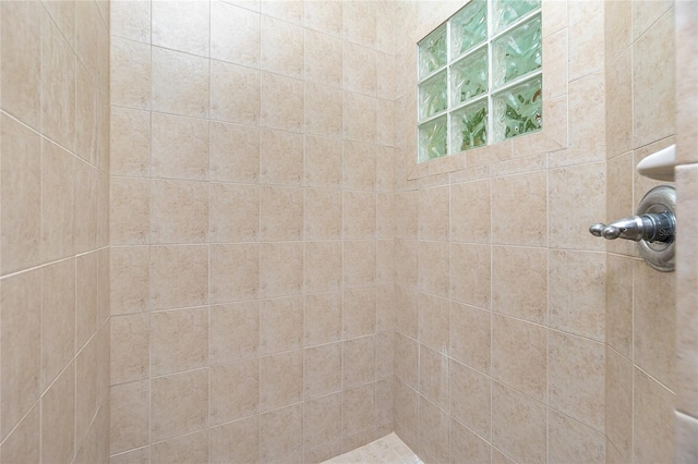 bathroom with tiled shower