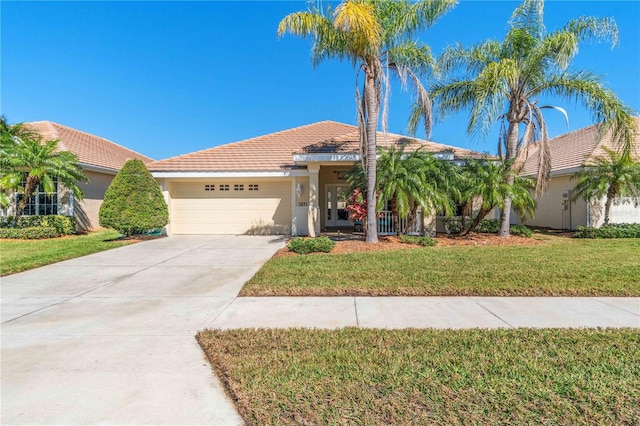 view of front of property featuring a garage and a front lawn