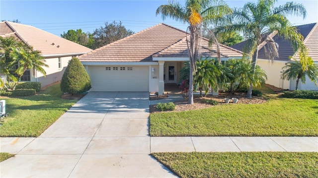 view of front of home with a garage and a front yard