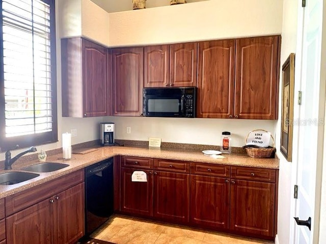 kitchen featuring sink, black appliances, and light tile patterned flooring