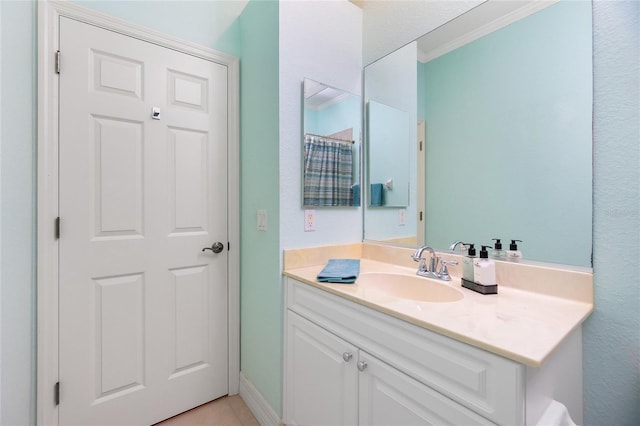 bathroom with crown molding and vanity