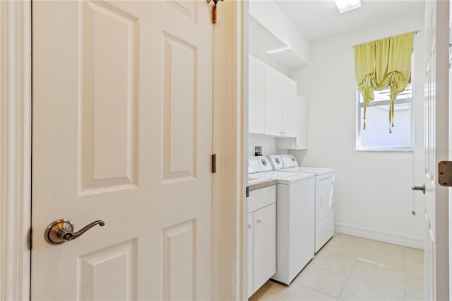 laundry area featuring cabinets, separate washer and dryer, and light tile patterned floors