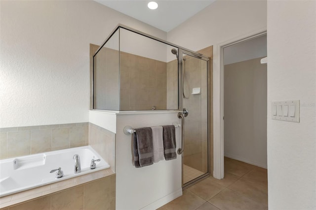 bathroom featuring tile floors and independent shower and bath