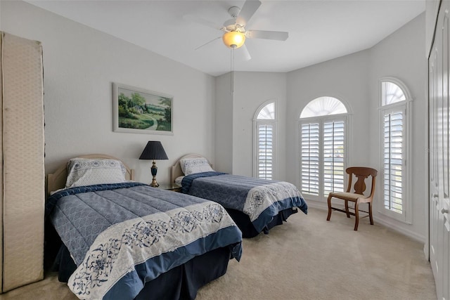 carpeted bedroom featuring lofted ceiling and ceiling fan