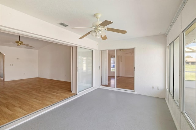 empty room featuring ceiling fan and light hardwood / wood-style flooring