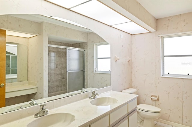 bathroom featuring tile patterned flooring, toilet, an enclosed shower, and vanity