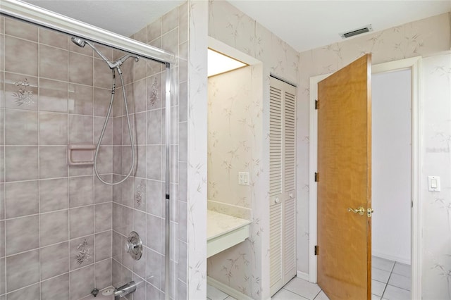 bathroom featuring a shower with door and tile patterned floors